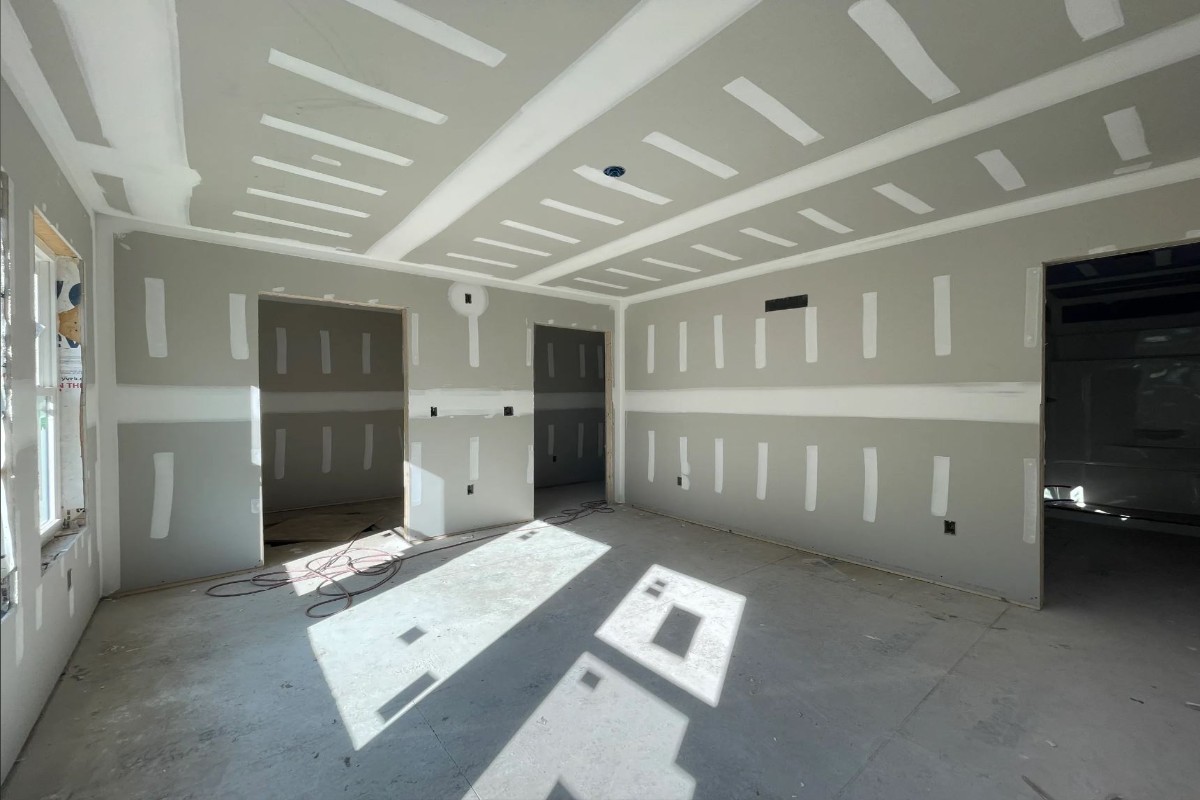 Drywall installers hanging panels on walls and ceilings