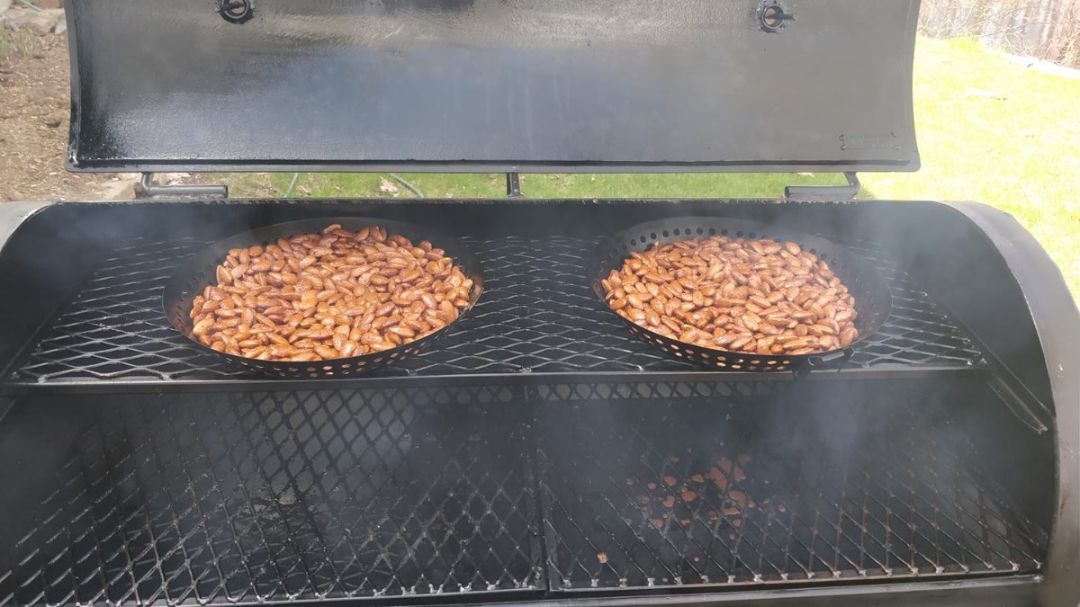 Artisanal smoked nuts and spices in rustic bowls