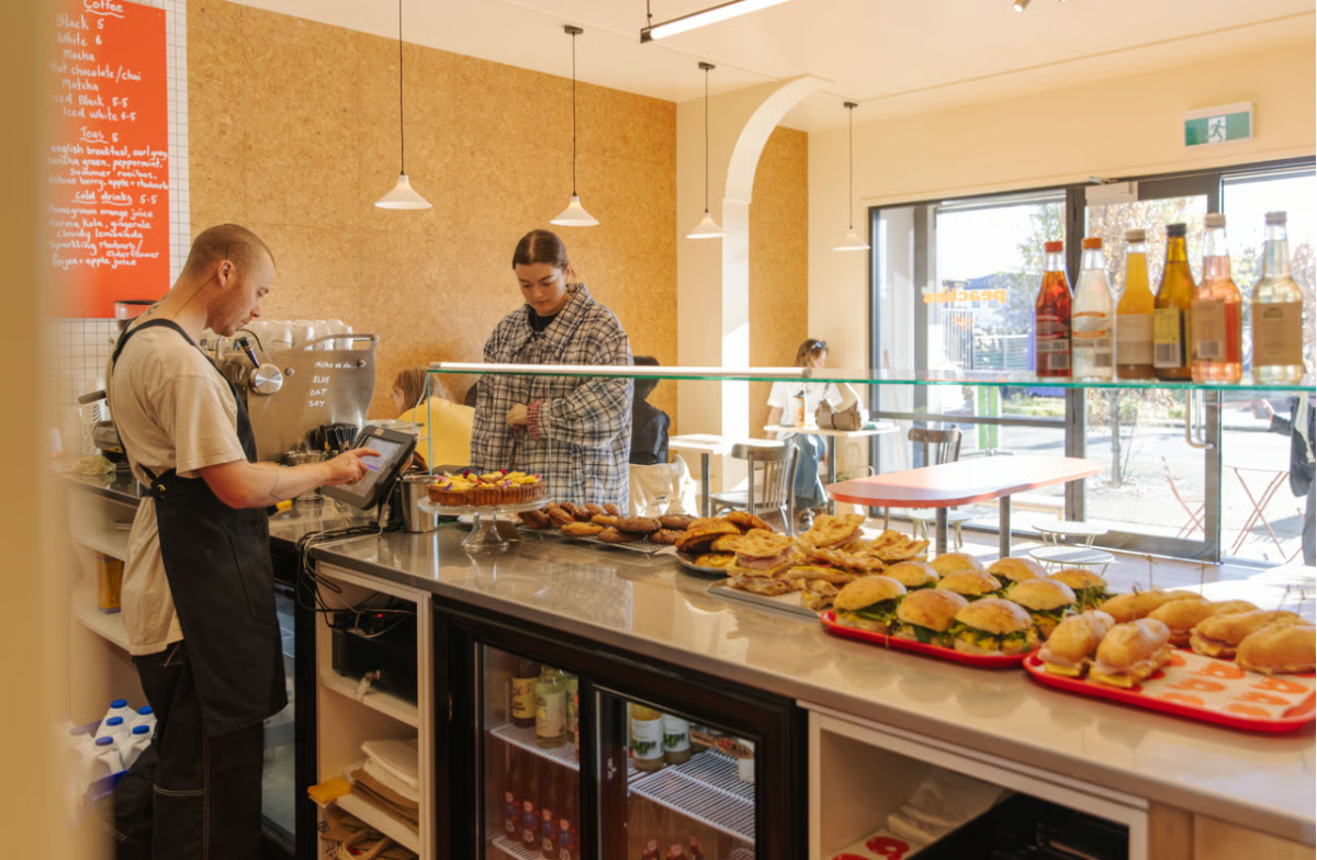 Standing event at Peaches café with guests enjoying drinks and canapés