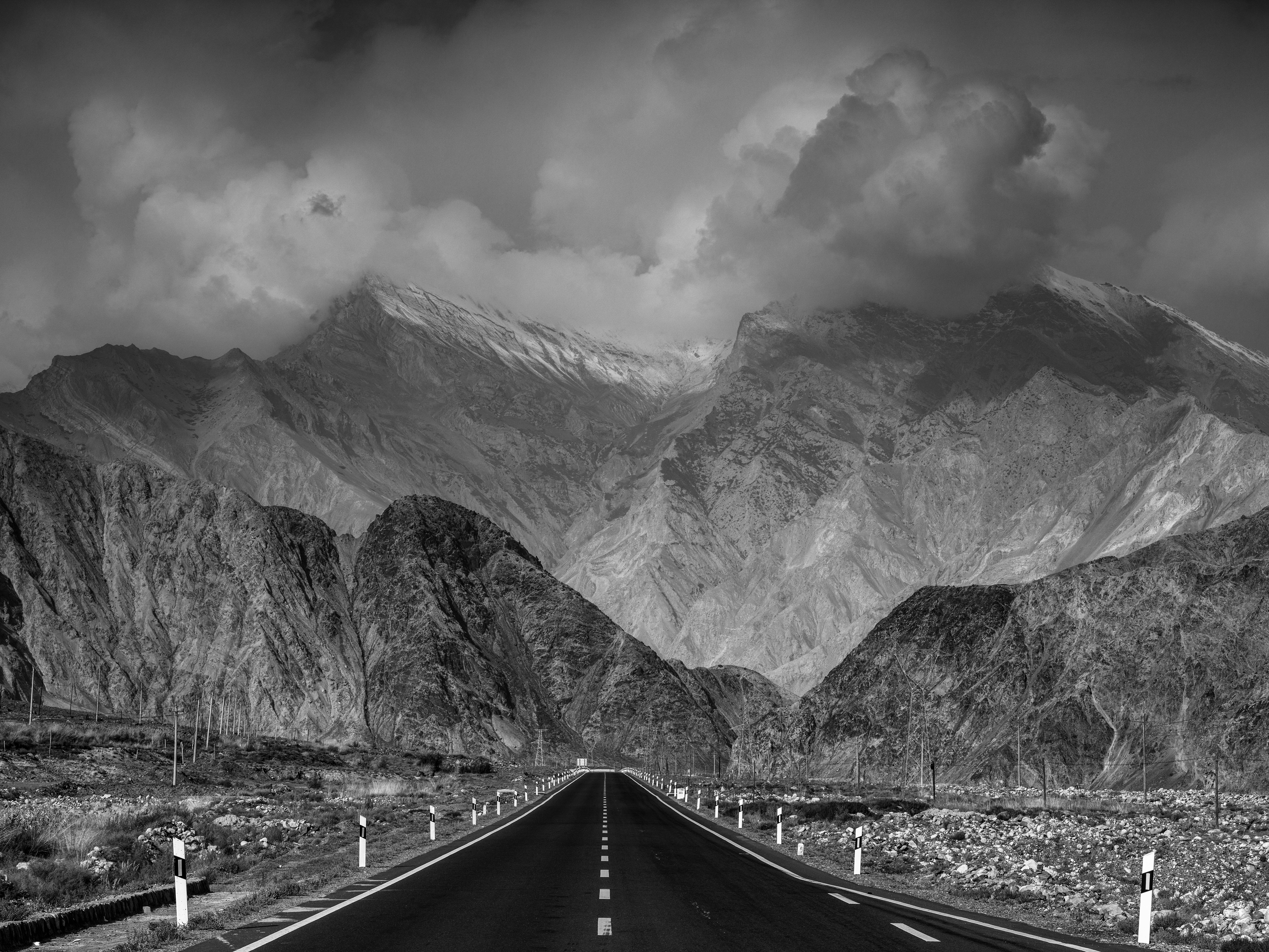 Road leading toward dramatic mountain range